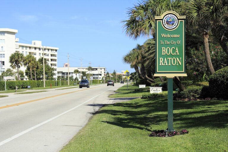 Sign that states “Welcome to the city of Boca Raton” on the Side of a road.